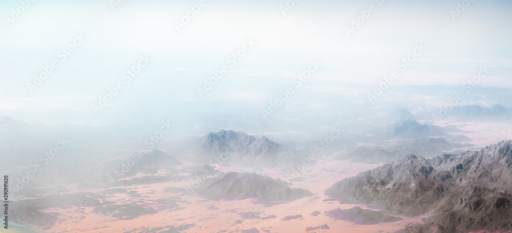 panorama from the airplane window to the mountains and desert in Egypt