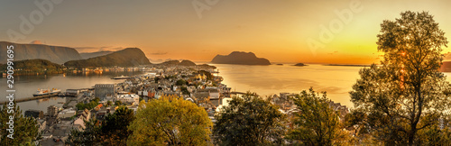 Alesund is a port and tourist city at the entrance to the Geirangerfjord.  Cityscape image of Alesund  at dawn. photo