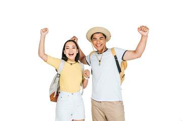 two happy asian tourists showing yes gestures while smiling at camera isolated on white