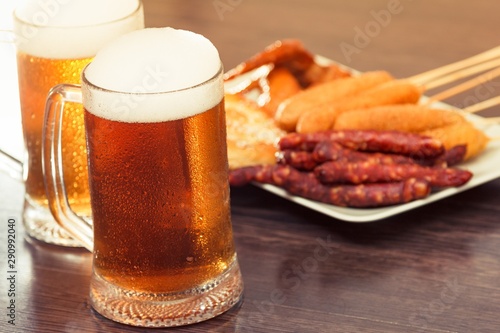 Beer glass alcohol drink with food sausage   grilled top.