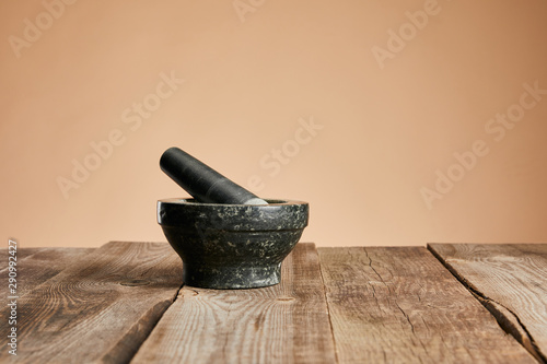 grey stone mortar on wooden table isolated on brown