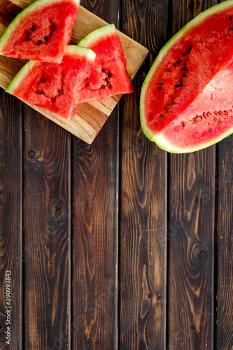 Pieces of watermelon on wooden background top view space for text
