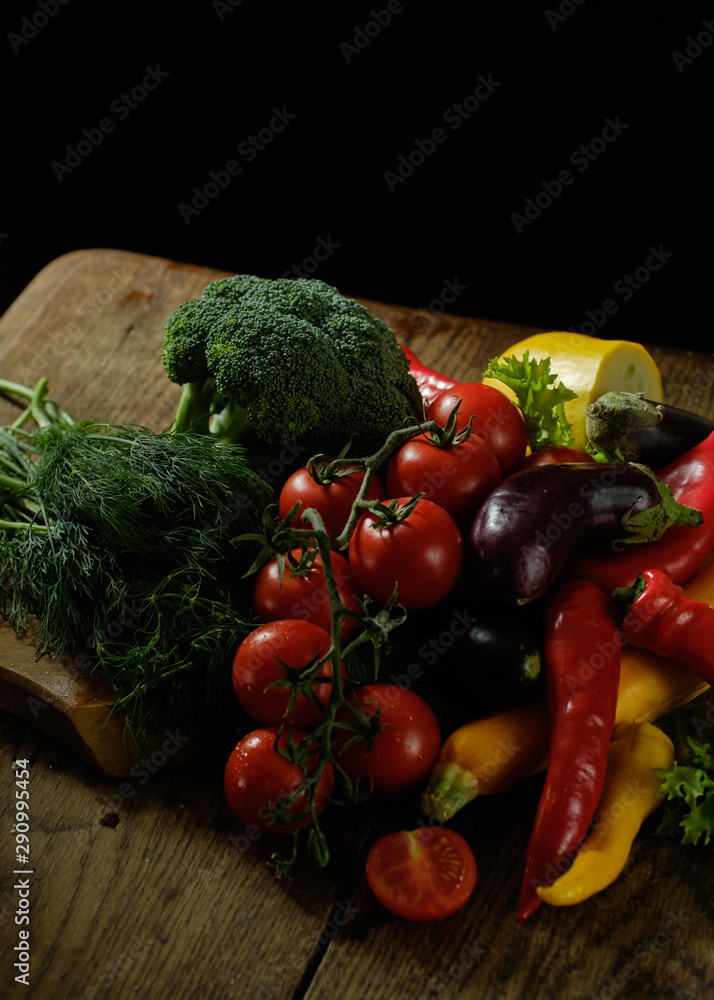 A lot of vegetables lies on a wooden table A lot of vegetables lies on a wooden table