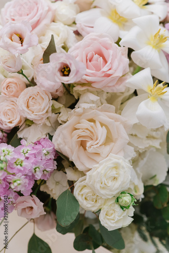 Gentle white, pink fresh wedding flowers. A large bouquet of fresh colors of light on the groom and bride 's table