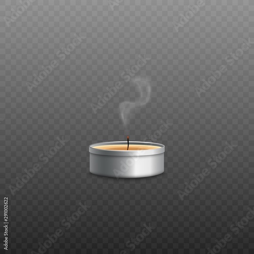 Yellow wax tealight candle in round silver metal container with fire blown out