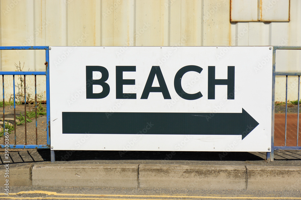 A sign showing the way to the beach