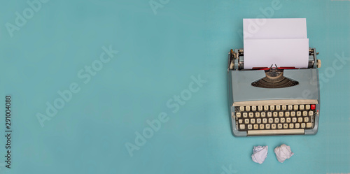 Vintage typewriter and crumpled papers with copy space banner