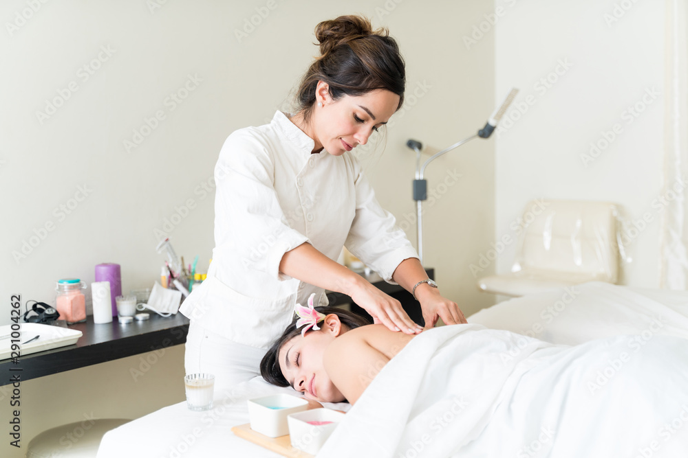 Therapist Pampering Woman With Relaxing Back Rub Therapist Pampering Woman With Relaxing Back Rub