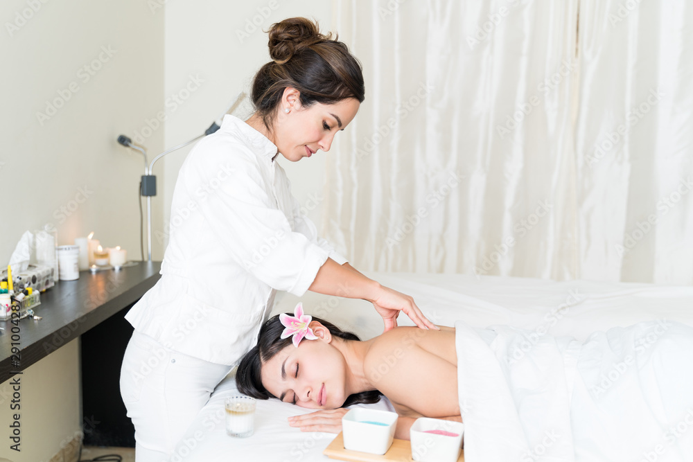 Hispanic Female Customer Receiving Back Massage Hispanic Female Customer Receiving Back Massage