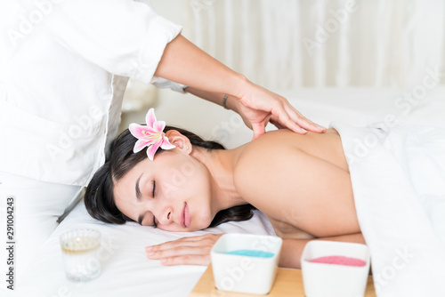 Masseuse Massaging Woman's Back At Spa