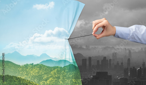 hand pulling nature cityscape curtain to gray cityscape, environmental protection concept photo