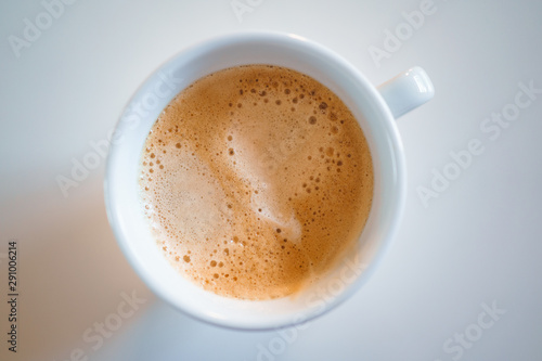 Coffee cup with coffee top down closeup