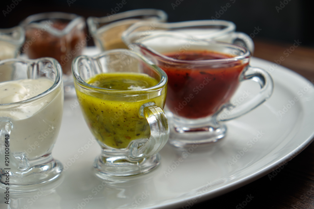 sauces in bowls on a dark wooden background. menu for catering sauces in bowls on a dark wooden background. menu for catering