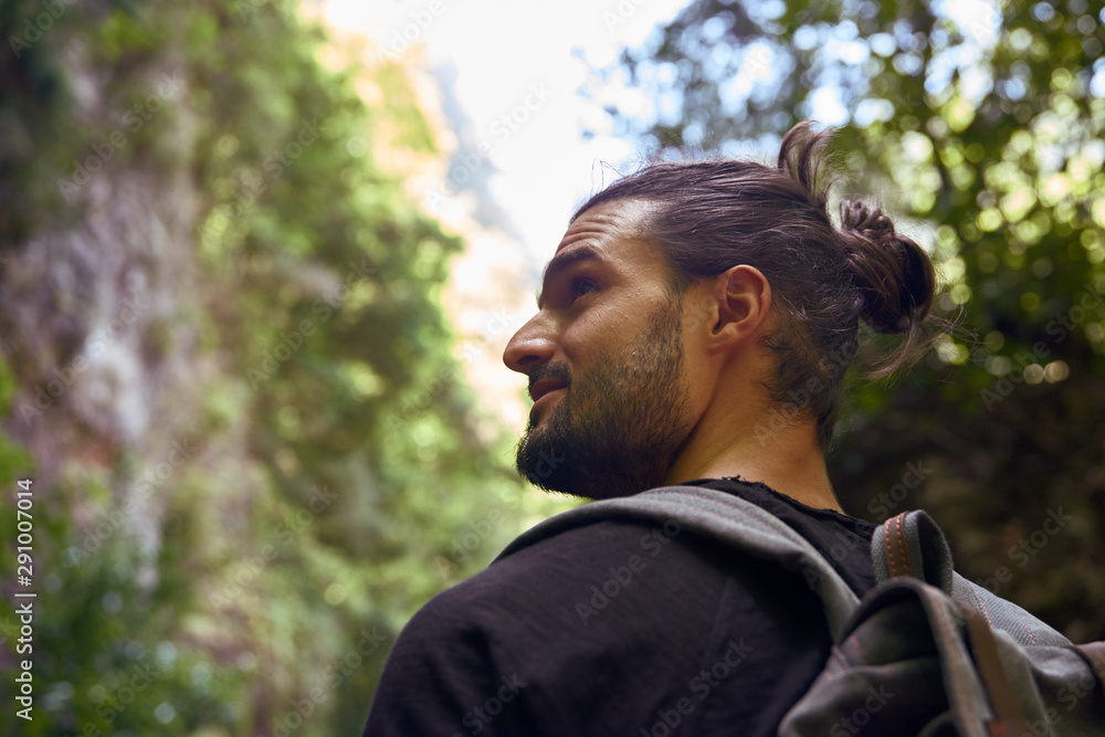 Man walking in a forest with trees Man walking in a forest with trees