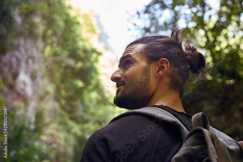 Man walking in a forest with trees