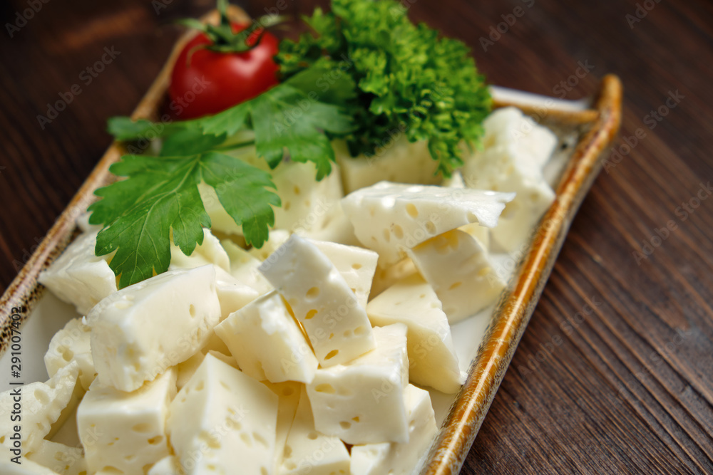 Cheese platter on a dark background. Food styling. Restaurant menu Cheese platter on a dark background. Food styling. Restaurant menu