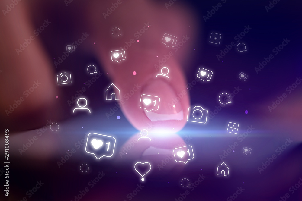 Finger touching phone with social media concept and dark background Finger touching phone with social media concept and dark background