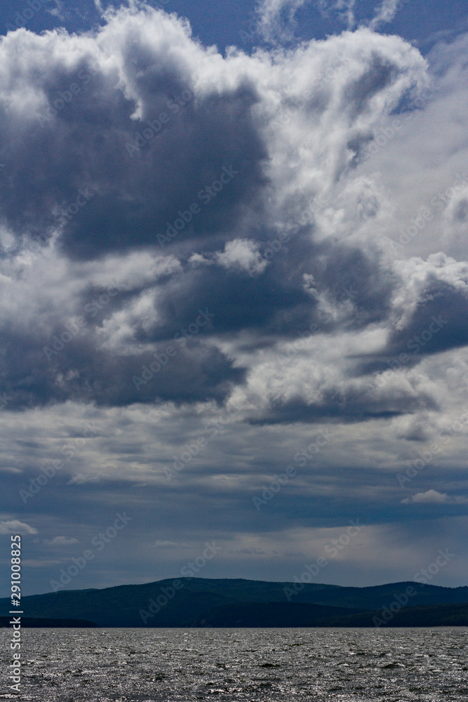 Naklejka premium Landscape Sea sky and forest on a cloudy day