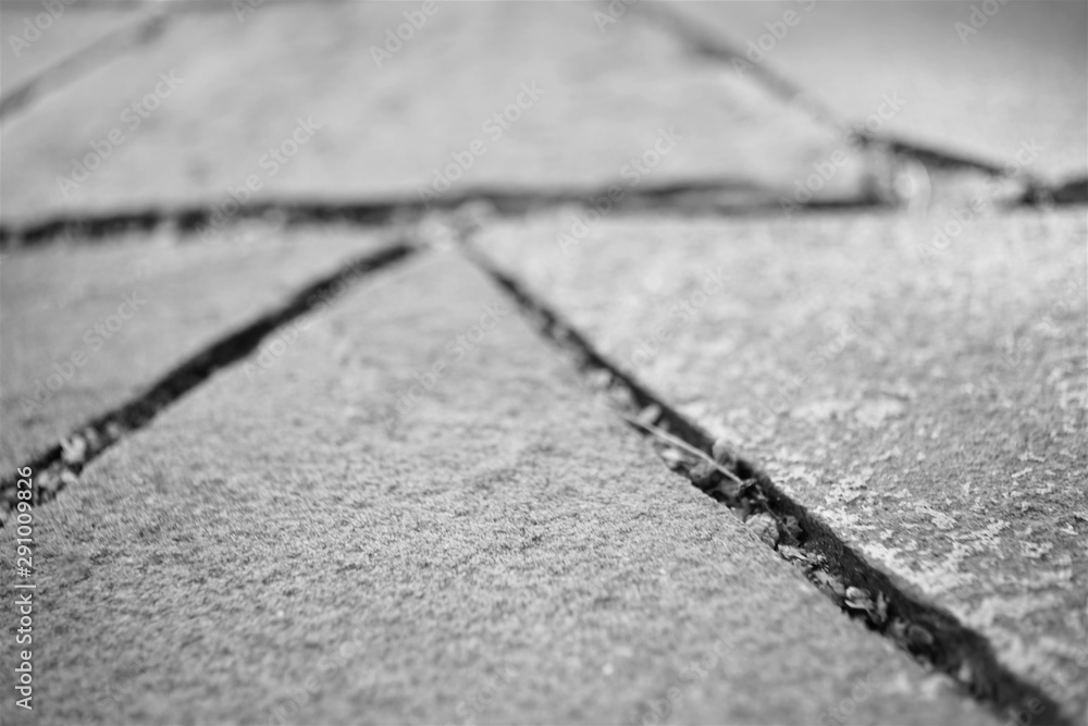 road surface made of natural wild stone closeup, black and white photo