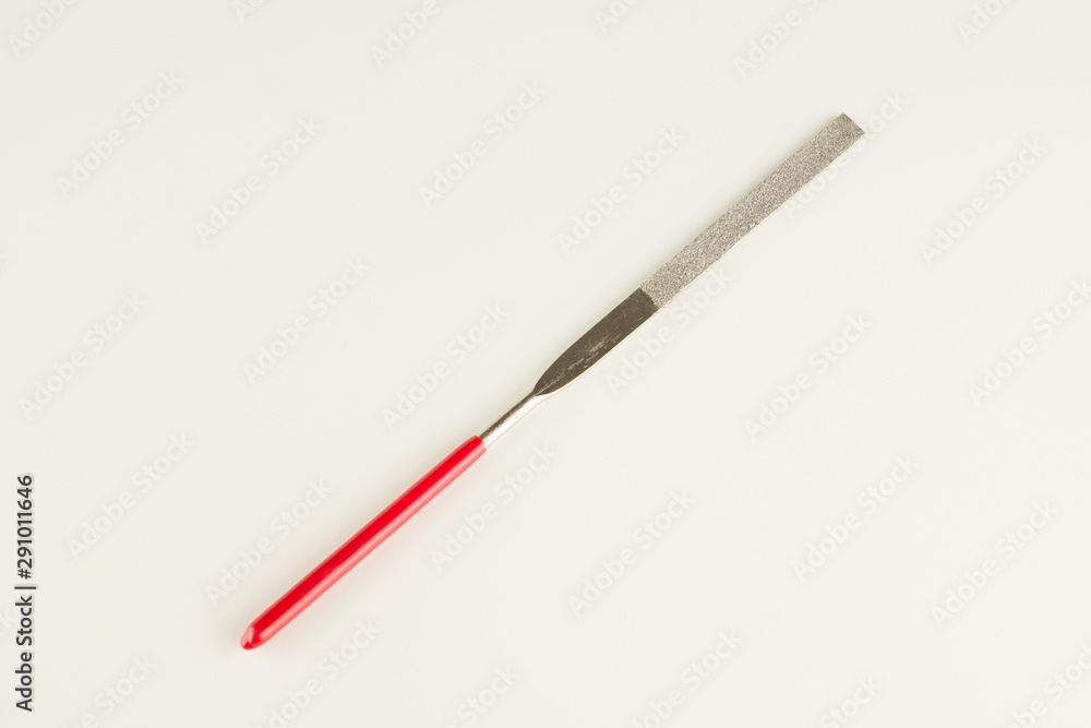 file with a long working part and a red dielectric handle file with a long working part and a red dielectric handle
