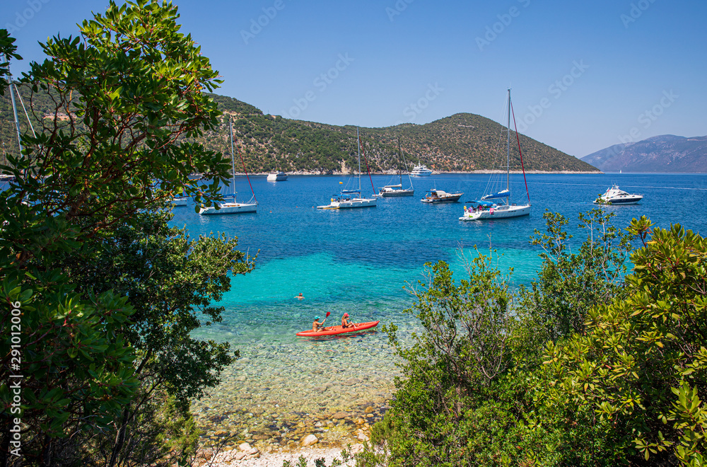 Summer sunny day sailboats anchored in the Antisamos bay, Kefalonia island, Ionian sea, Greece.