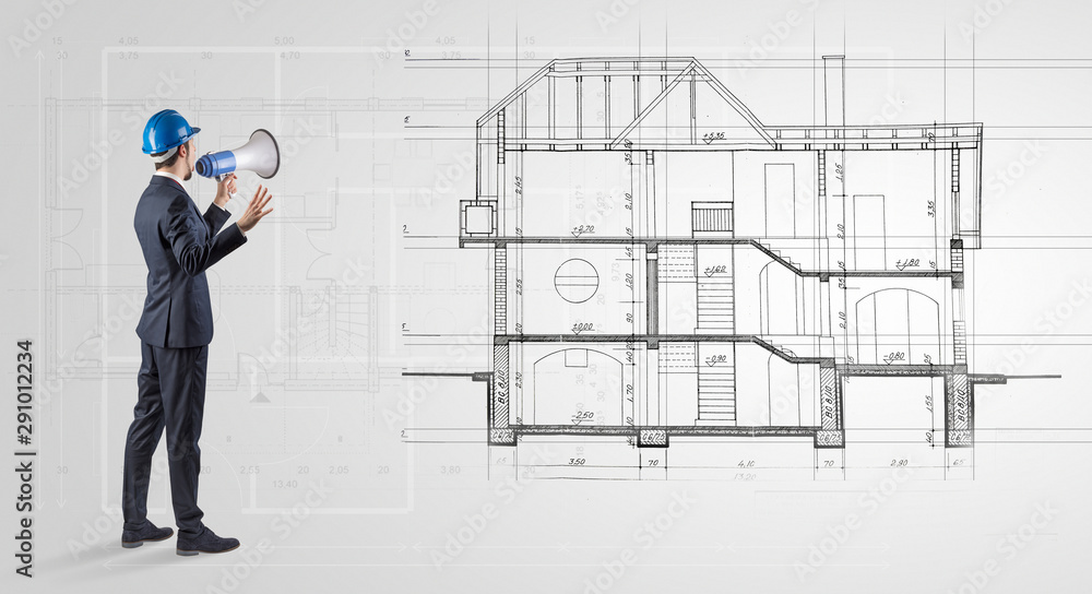 Architect watching a 2 dimension house plan Architect watching a 2 dimension house plan
