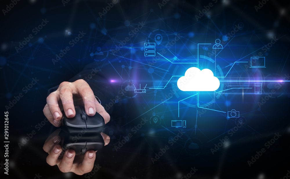 Hand using wireless mouse in a dark environment with cloud technology and online storage concept Hand using wireless mouse in a dark environment with cloud technology and online storage concept