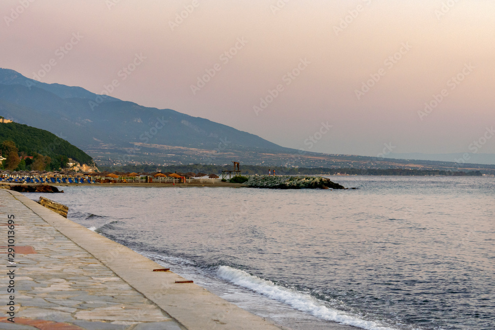 Pier and beach at sunrise on Platamonas in Greece