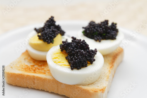 Caviar on egg with toast