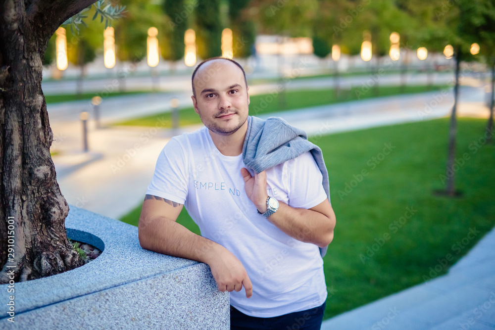 Portrait of a smiling bald handsome man of 30 years old in a modern ...