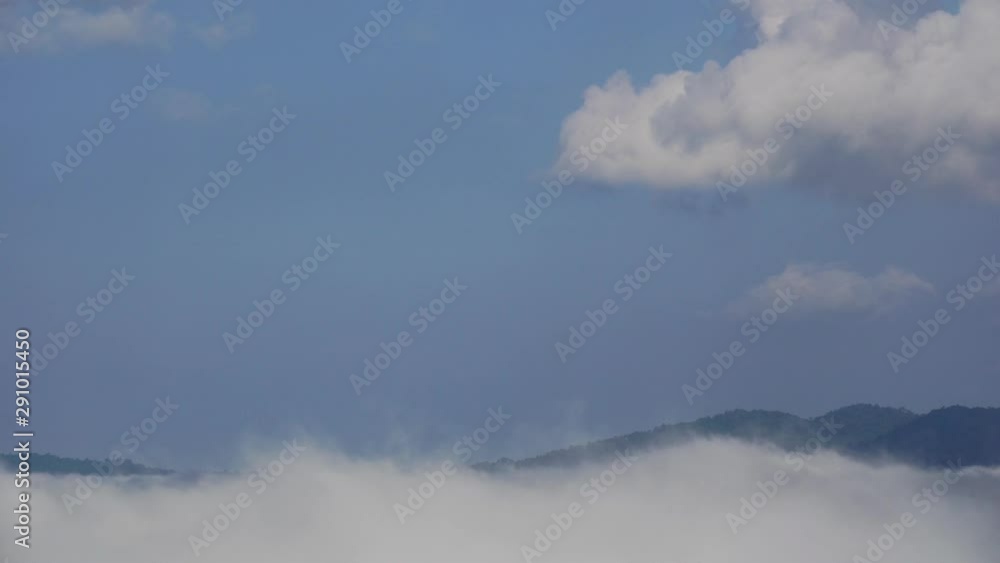 The movement of the fog through the mountains in the morning. Cumulus clouds follow the wind. The fog at Khao Kho, Phetchabun, Thailand The movement of the fog through the mountains in the morning. Cumulus clouds follow the wind. The fog at Khao Kho, Phetchabun, Thailand