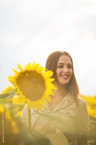 Beautiful young woman posing with sunflower