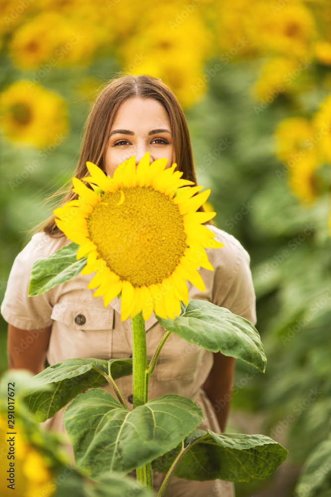 Beautiful young woman posing with sunflower Beautiful young woman posing with sunflower