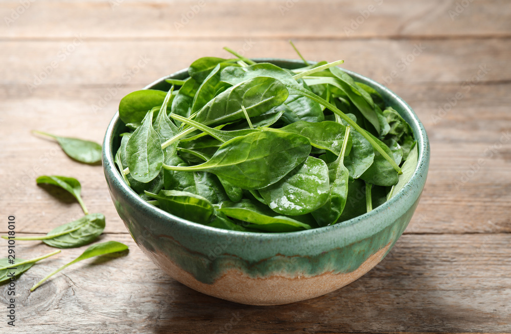Fresh green healthy spinach on wooden table Fresh green healthy spinach on wooden table