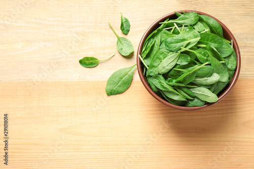 Fresh green healthy spinach on wooden table, flat lay. Space for text