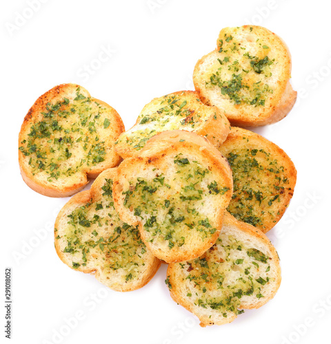 Slices of toasted bread with garlic, cheese and herbs on white background, top view