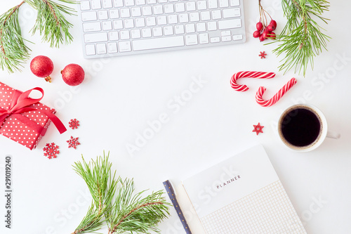 Flat lay christmas home office desk with pine branches and keyboard, christmas decorations  on a white background © maria_lh