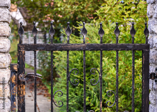 wrought iron fence gate and on stone fence