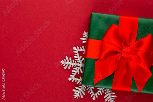 Christmas, holiday present box on red background. © gitusik