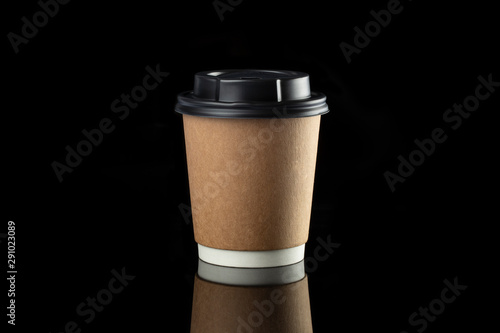 Cardboard coffee cup with lids. Black background.