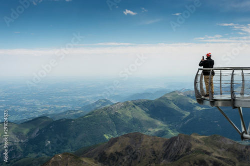 A man contemplates the Pyrenees Mountains from the viewpoint of the astronomical observatory of the Pic du Midi in Bigorre. photo