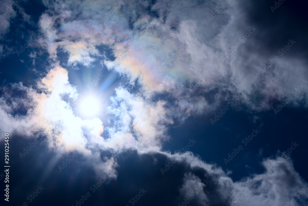 Bright disk sun with rays among the clouds. Concept - dramatic scene in nature