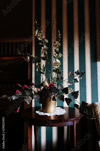 Still life compositin in room with green and white wallpaper photo