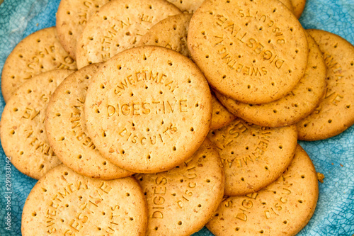 Round digestive biscuits on a turquoise plate photo