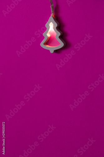 blank for a New Year's card in a minimalist style - Glowing Christmas tree on a pink background