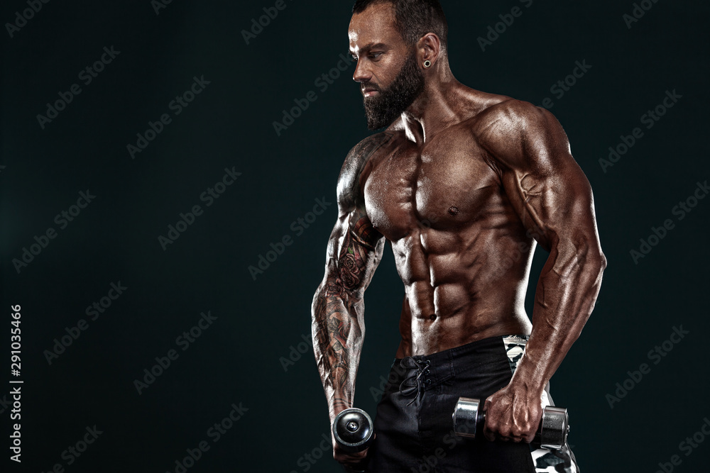 Strong and fit man bodybuilder. Sporty muscular guy with dumbbells. Spot and fitness motivation. Strong and fit man bodybuilder. Sporty muscular guy with dumbbells. Spot and fitness motivation.