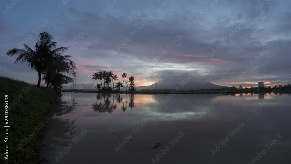 Timelapse reflection sunrise red cloud with fisheye lens. Beautiful coconut trees and electric tower over the hill. Timelapse reflection sunrise red cloud with fisheye lens. Beautiful coconut trees and electric tower over the hill.