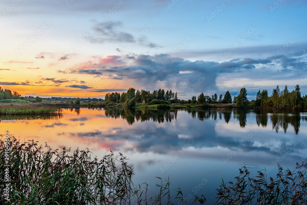 Fototapeta premium Autumn landscape with lake at sunset light