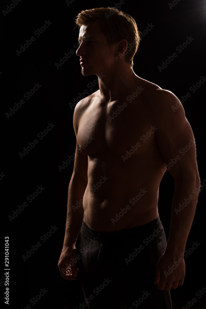 Male fitness model showing muscles in studio Stock Photo Adobe Stock
