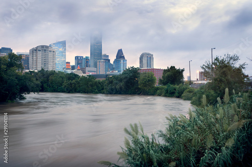 Spilled river and water flowing with great speed against the background of the city. Effects Tropical Storm Imelda. Houston, Texas, US photo